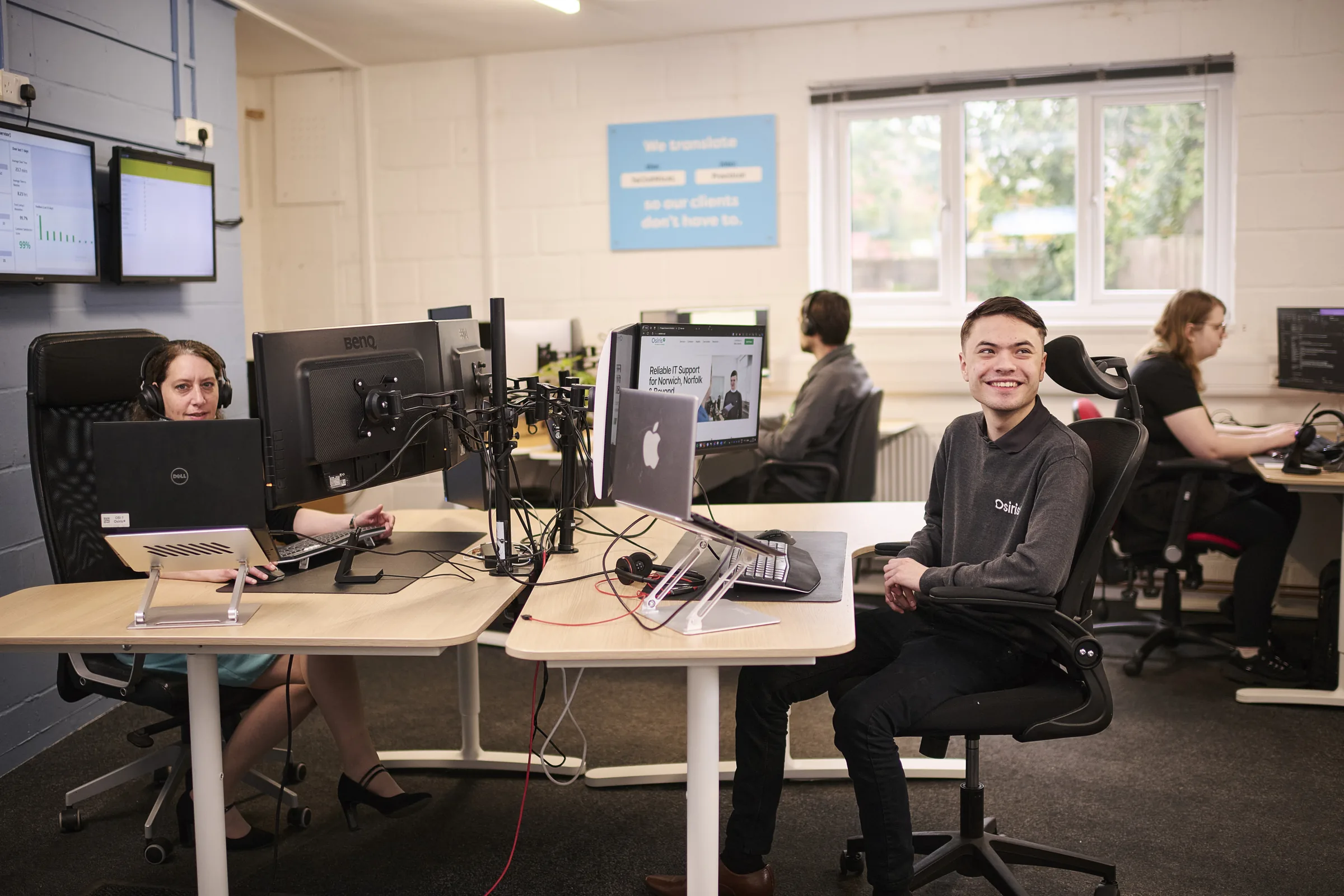 Osiris support engineers working across service desk workstations.