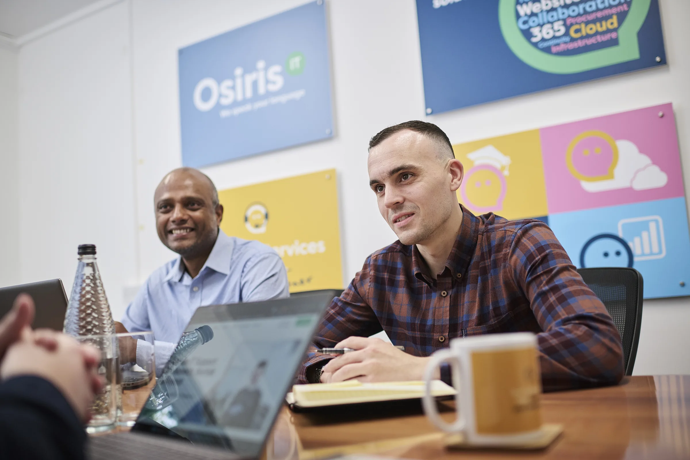 Osiris consultants around a meeting table during a commercial technology planning session.