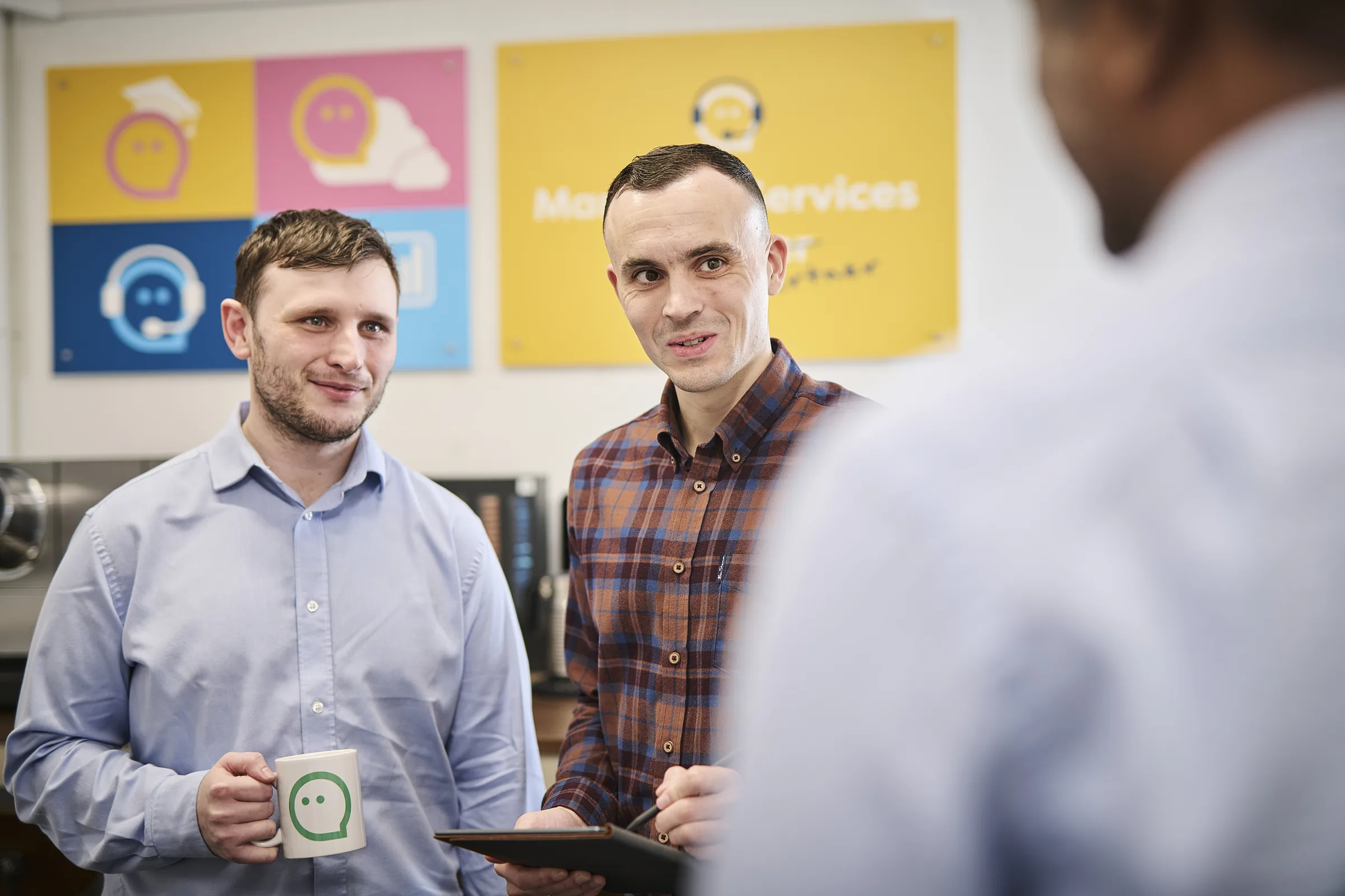 Osiris team presenting Cyber Essentials certification credentials during a client conversation.
