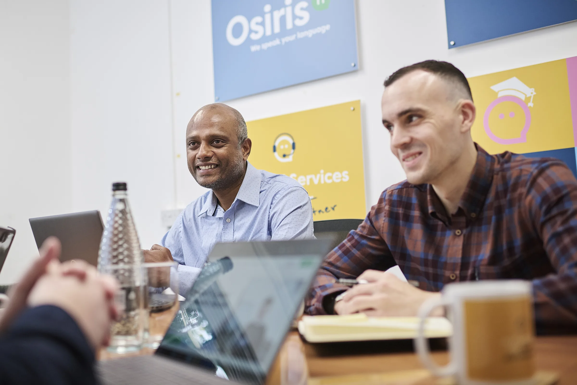 Osiris consultants around a meeting table during a commercial technology planning session.